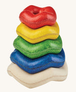 PlanToys Wave Stacker wooden baby toy with rainbow rings.