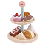 one tier of cakes and biscuits play food and the second tier used as a plate. White background.