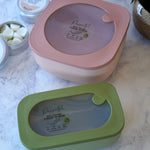 Two Poppets Reusable Baby Wipes Containers on a marble style surface. 