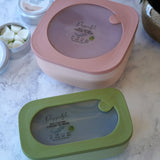 Two Poppets Reusable Baby Wipes Containers on a marble style surface. 