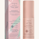 Pink with green leaves hair growth tonic box and a pink bottle on a cream background. 