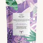 Purple with green leaves postpartum recovery tea pouch on a white background.