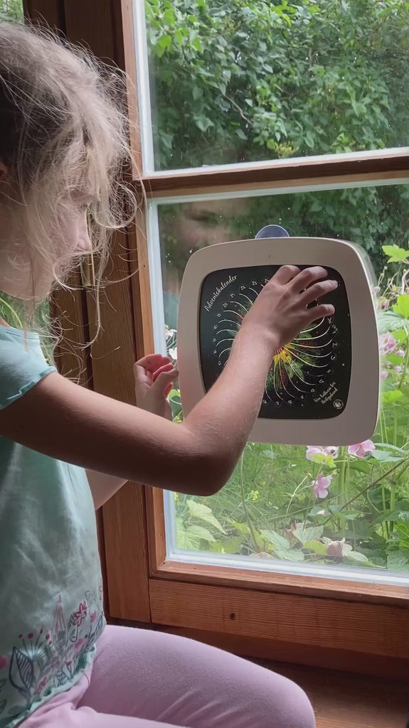 A short video showing a girl opening a window from the Toverlux 12 nights advent calendar available at Babipur. Silhouette is inside a magic frame hanging on a window