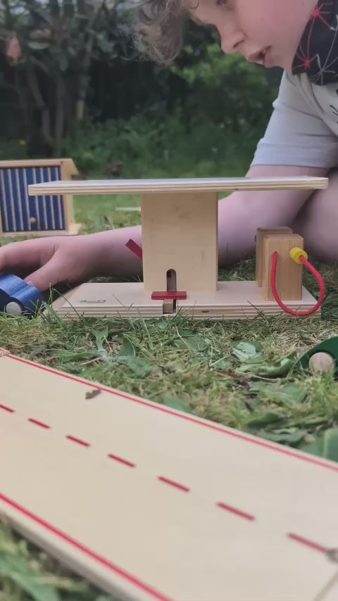 Beck Holzspielzeug Wooden Toy Car Garage Petrol Station with two petrol pumps and a working raised platform for car repairs.