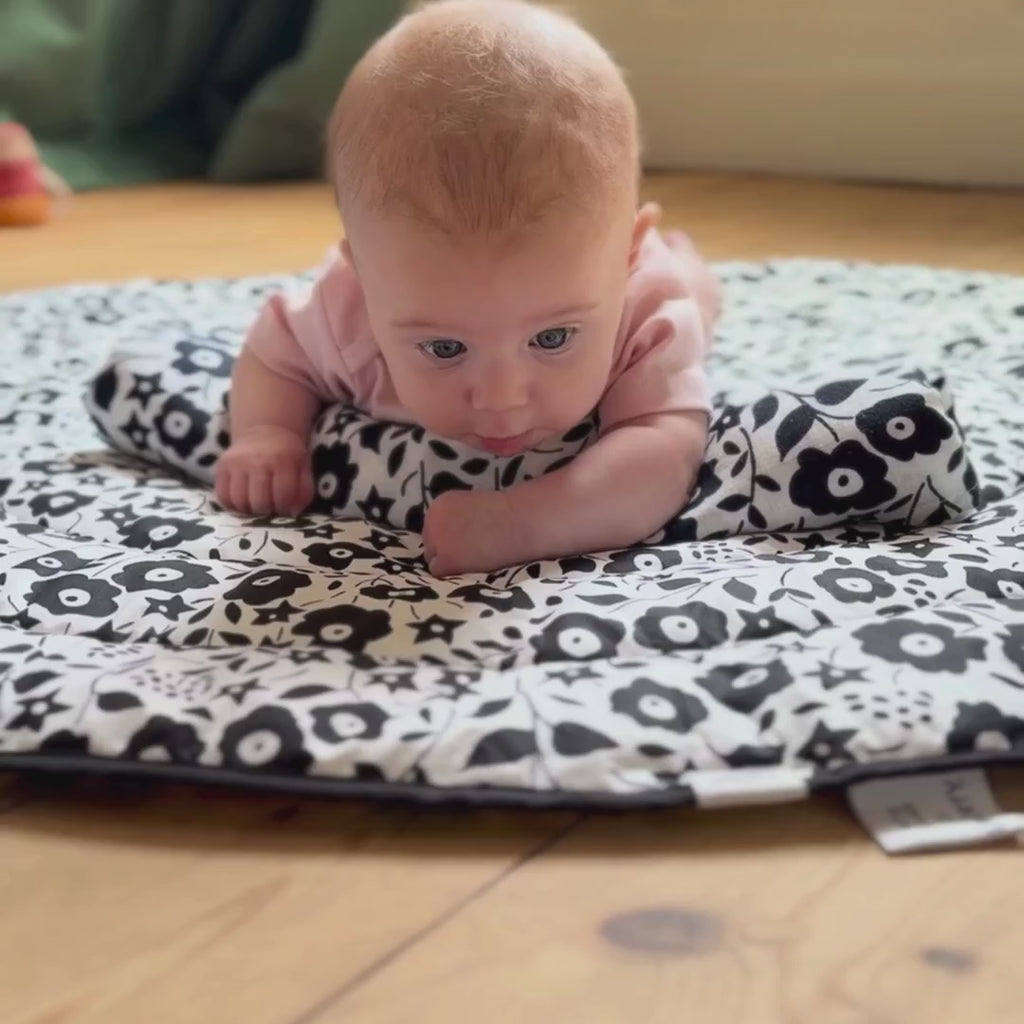 Short video showing a baby crawling on top of the Etta Loves x Liberty reversible sensory playmat on the Fairford shadow design side