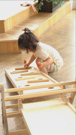 Baby playing with Triclimb Miri Sticks