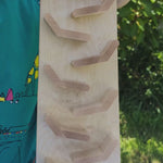 A video of the wooden Beck Cascading ‘Tower Running Track’ with Race Cars in action, filmed outdoors in the Babipur garden. Small wooden cars race down a series of sloped wooden tracks, flipping from one level to the next