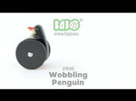 A video showing the Bajo wobbling penguin push along wooden toy in motion. As the wheels turn the penguin's body moves forward and back.