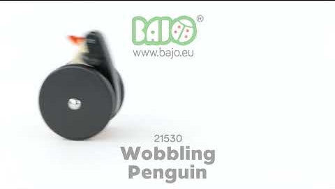 A video showing the Bajo wobbling penguin push along wooden toy in motion. As the wheels turn the penguin's body moves forward and back.
