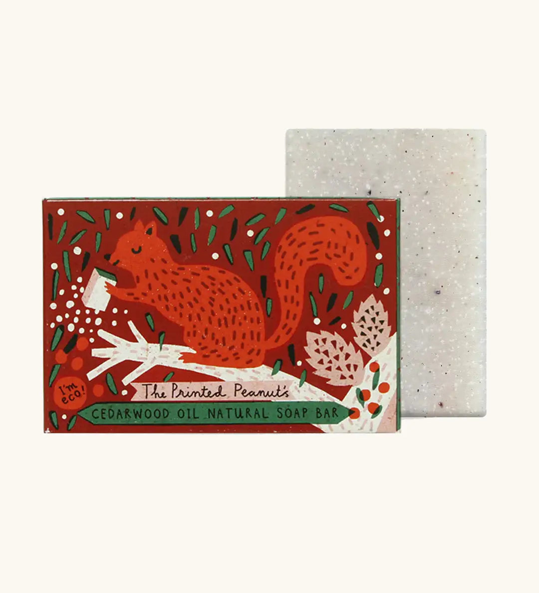 The Printed Peanut cedarwood natural handmade soap standing next to it's decorative cardboard box packaging of a red squirrel 
