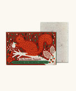 The Printed Peanut cedarwood natural handmade soap standing next to it's decorative cardboard box packaging of a red squirrel 