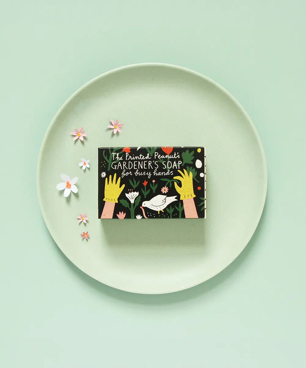 The Printed Peanut Gardener’s peppermint soap gift box on green plate with flowers, natural exfoliating poppyseed soap for gardeners.