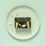 The Printed Peanut Gardener’s peppermint soap gift box on green plate with flowers, natural exfoliating poppyseed soap for gardeners.