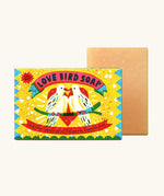 Printed Peanut love bird natural handmade soap bar standing next to its decorated box showing 2 white birds infront of a heart