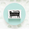 The Printed Peanut Black Cat charcoal soap gift box displayed on blue background with bubbles, natural soap with rosemary and lime.