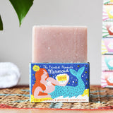 Printed Peanut rose geranium natural soap bar placed on top of the mermaid themed illustrated packaging box.