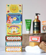 Stack of Printed Peanut natural soaps in the illustrated boxes. Other Babipur hair and beauty products can be seen blurred in the background.