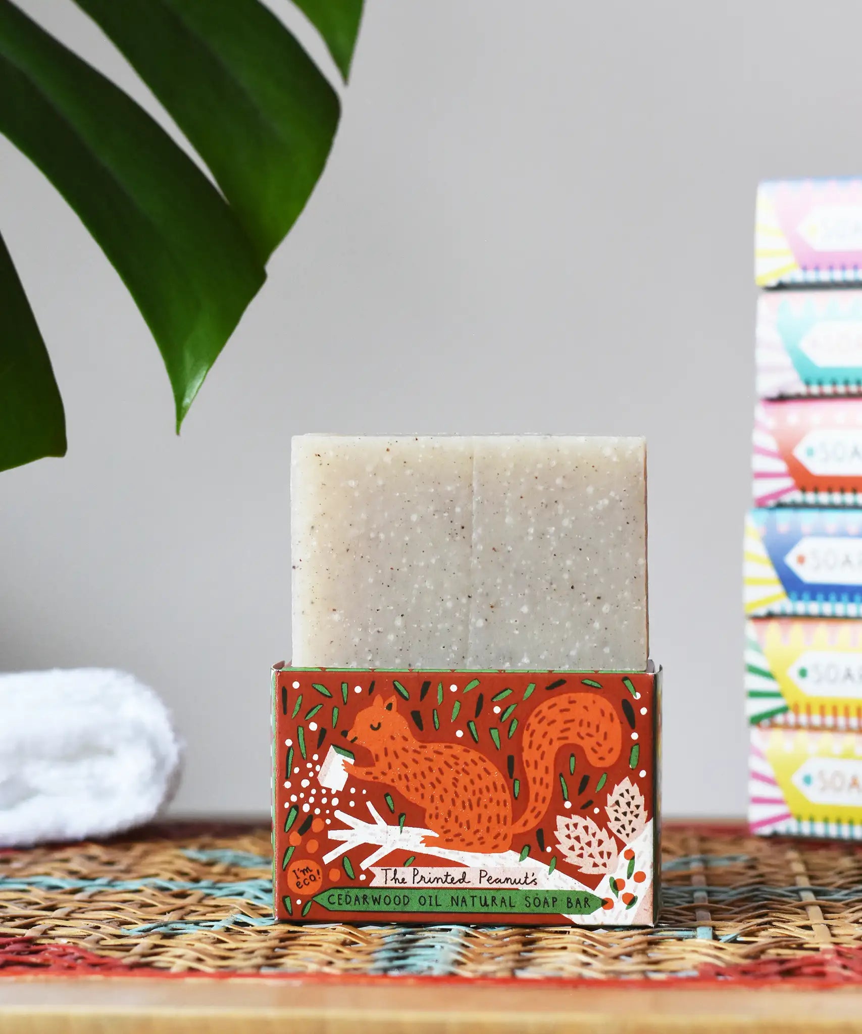 Printed Peanut cedarwood natural soap bar placed on a squirrel themed illustrated cardboard packaging box.