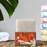 Printed Peanut cedarwood natural soap bar placed on a squirrel themed illustrated cardboard packaging box.
