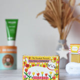 Printed Peanut tea tree and turmeric natural soap bar in it's yellow decorative white cat illustrated cardboard packaging box. 