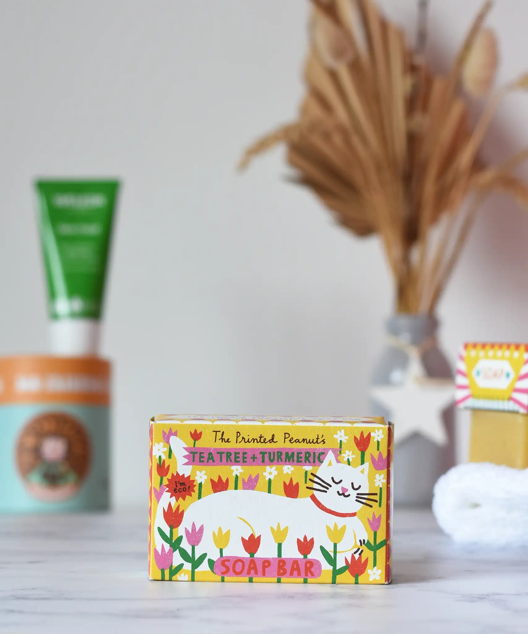 Printed Peanut tea tree and turmeric natural soap bar in it's yellow decorative white cat illustrated cardboard packaging box. 