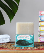 Printed Peanut aloe vera fragrance free natural handmade soap bar placed on it's decorative blue cardboard box showing a whale illustration.