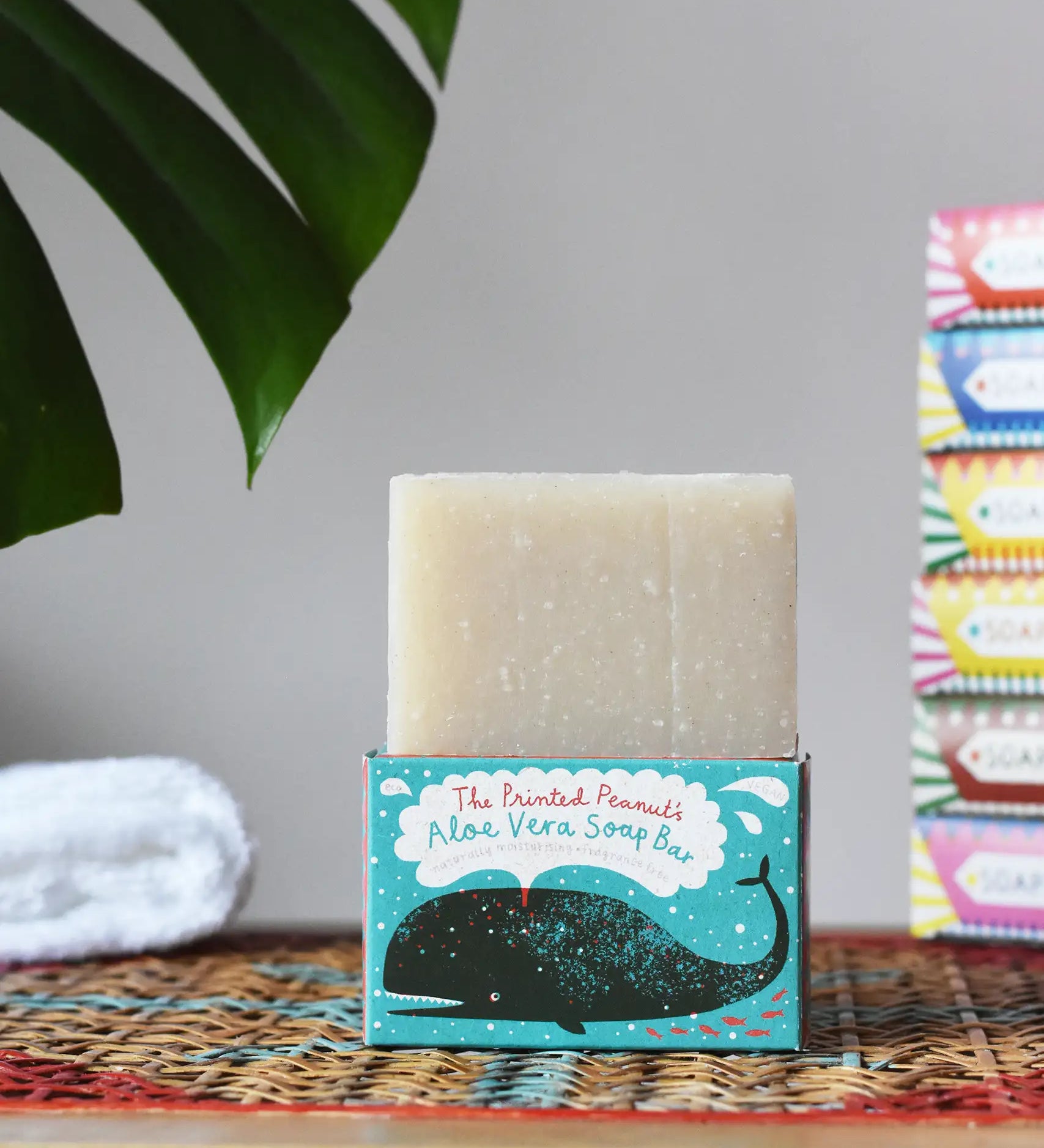 Printed Peanut aloe vera fragrance free natural handmade soap bar placed on it's decorative blue cardboard box showing a whale illustration.