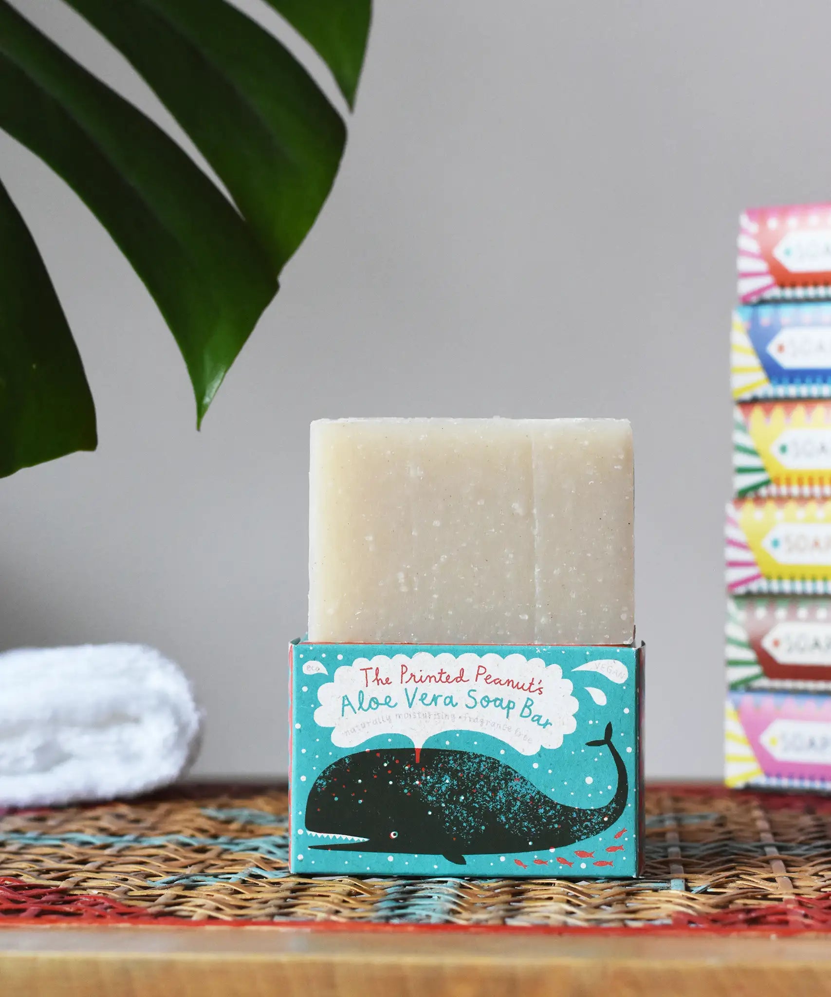 Printed Peanut aloe vera fragrance free natural handmade soap bar placed on it's decorative blue cardboard box showing a whale illustration.