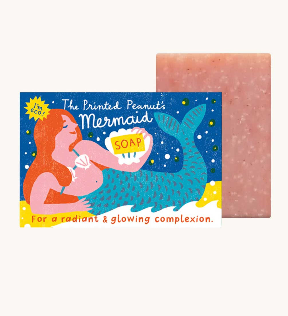 The Printed Peanut mermaid rose natural handmade soap. The decorative packaging box is shown next to the pink bar of soap. 