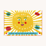 The Printed Peanut sunshine natural handmade orange and grapefruit soap. The bar is shown in a decorative packaging box. 