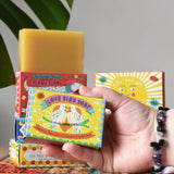 Printed Peanut tea tree, lemongrass, lavender and peppermint soap bar in a love bird themed illustrated box. Other Printed Peanut soaps can be seen stacked in the background.