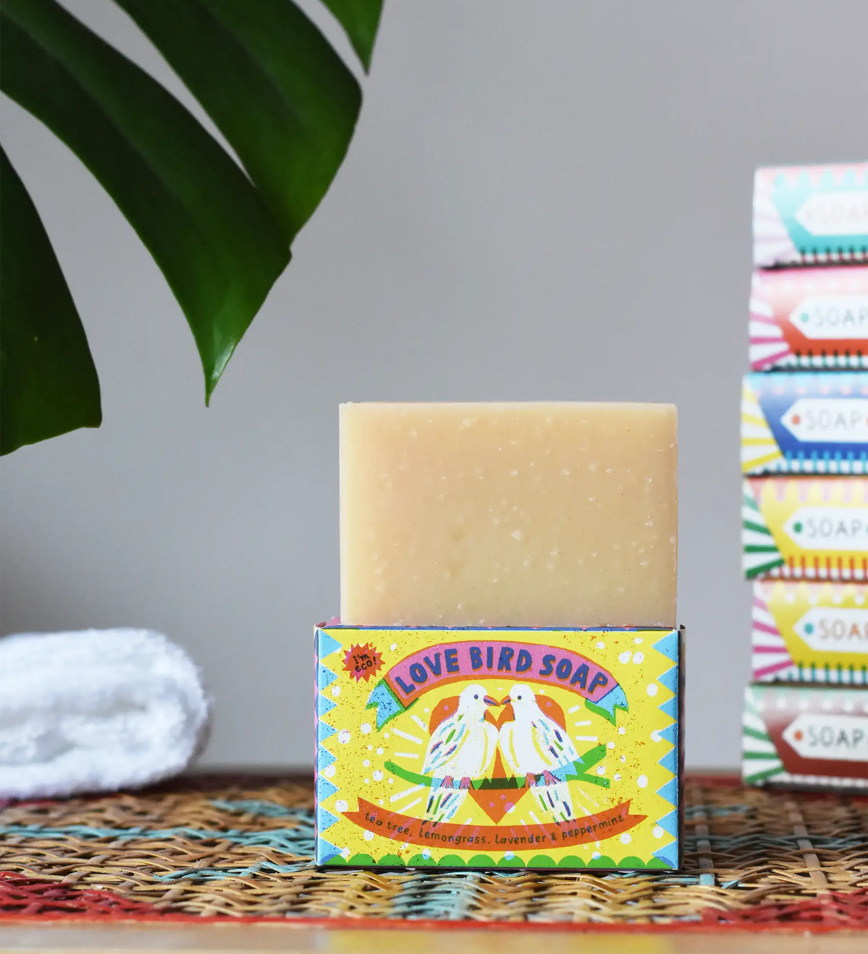 Printed Peanut tea tree, lemongrass, lavender and peppermint soap bar in a love bird themed illustrated box. The natural soap bar has been placed on top of the cardboard packaging box.