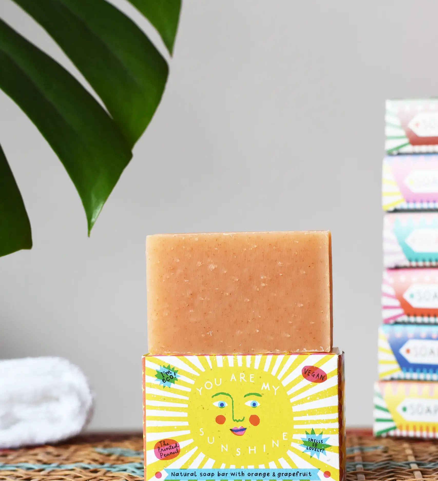 Printed Peanut orange and grapefruit natural soap bar placed on a you are my sunshine themed illustrated packaging box. 