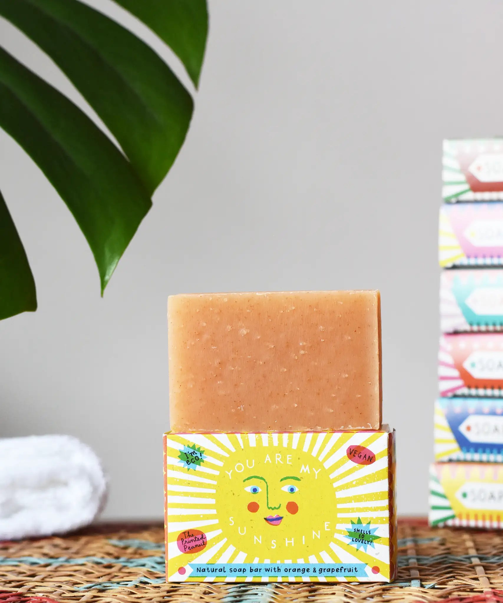 Printed Peanut orange and grapefruit natural soap bar placed on a you are my sunshine themed illustrated packaging box. 