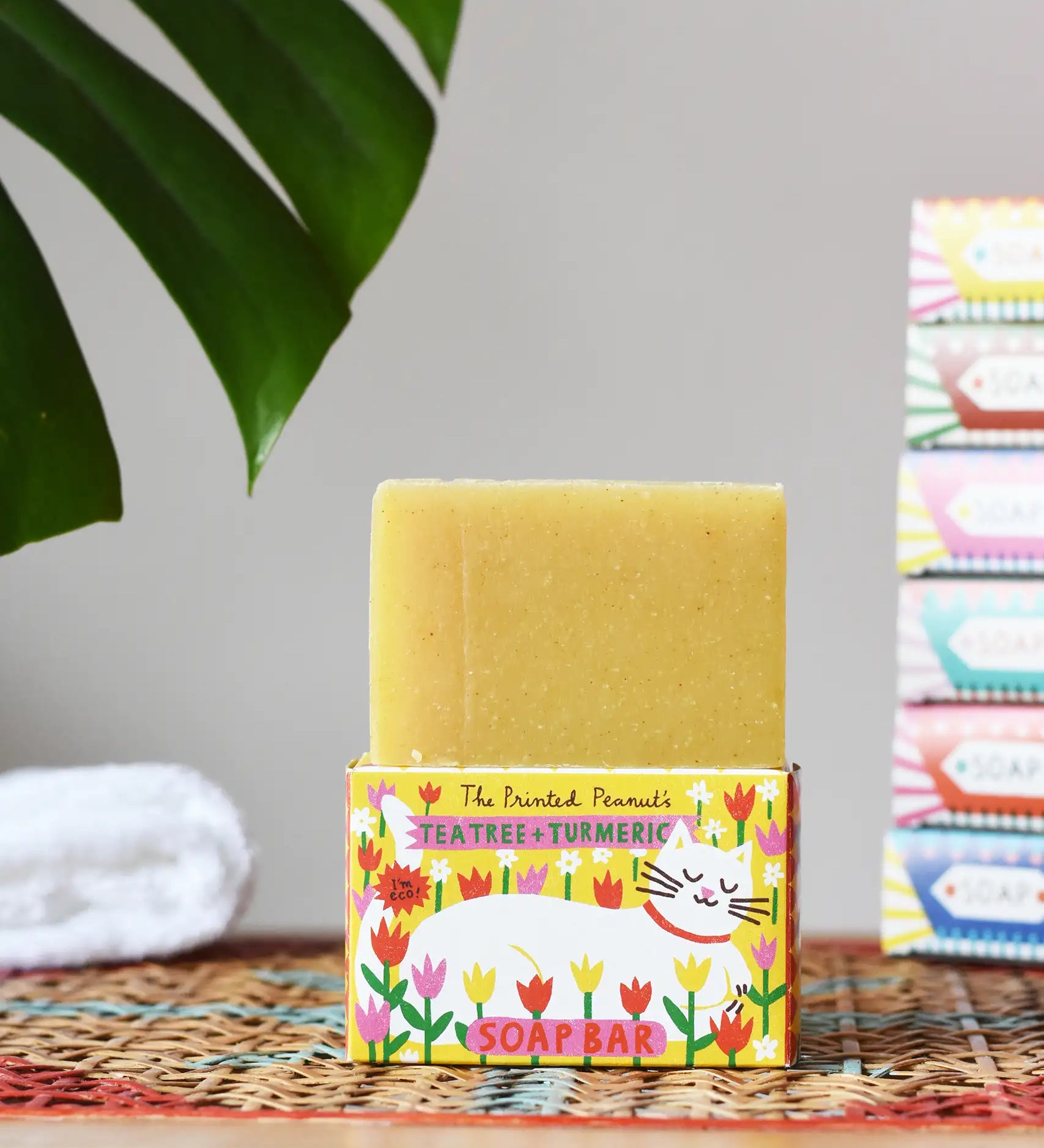 Printed Peanut tea tree and turmeric natural soap bar placed on its decorative cat illustrated cardboard packaging box. 
