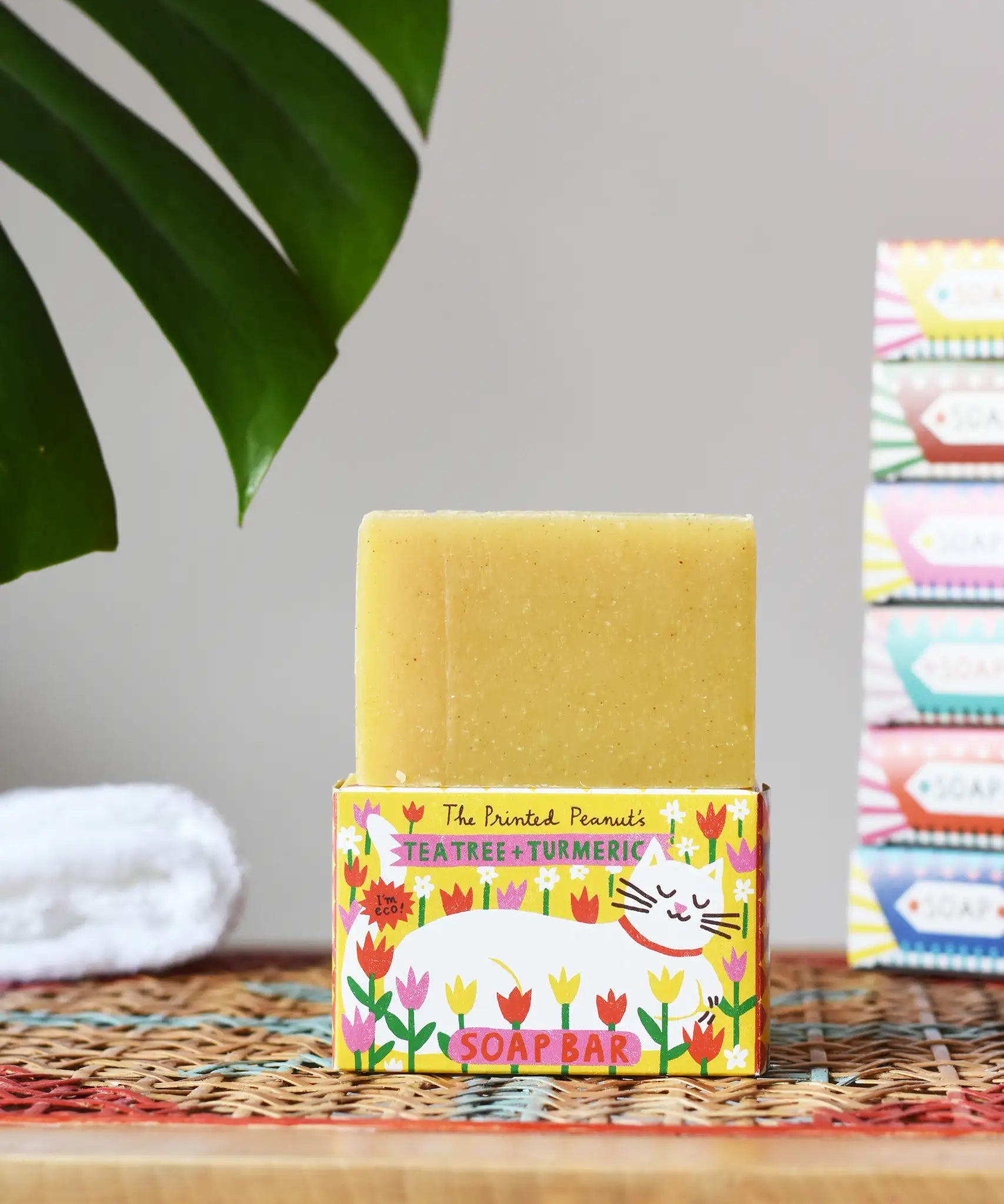 Printed Peanut tea tree and turmeric natural soap bar placed on its decorative cat illustrated cardboard packaging box. 