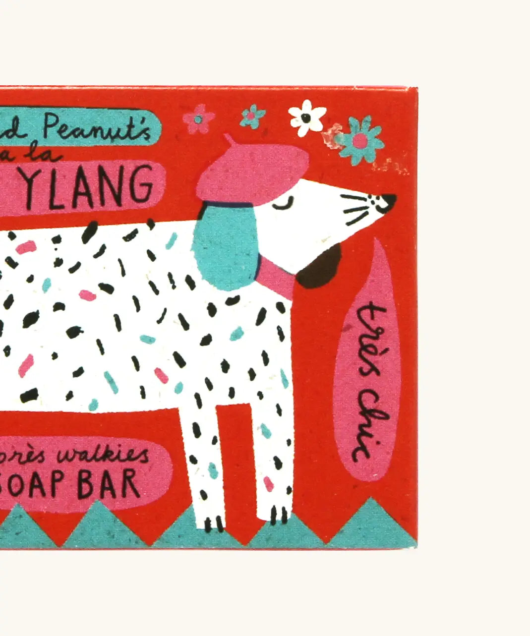 Close up of The Printed Peanut ylang ylang natural handmade soap red box showing a white dog illustration 