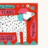 Close up of The Printed Peanut ylang ylang natural handmade soap red box showing a white dog illustration 