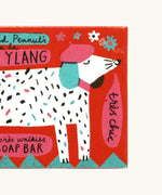 Close up of The Printed Peanut ylang ylang natural handmade soap red box showing a white dog illustration 