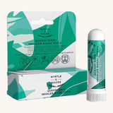 Green and white with leaves nasal stick box with nasal stick on a cream background.