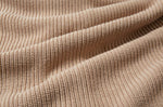 A close up of the material of the Rapanui Brook Organic Cotton Women's Knitted Cardigan. The material has been scrunched together.