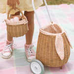 A view from the the back of the Olli Ella Rattan Bunny Luggy with Lining – Pansy Floral. A beautifully woven pull along Luggy basket with cream cotton lining with a vintage pansy floral pattern with bunny ears and a white fluffy tail
