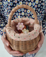 A child sat on a colourful basket