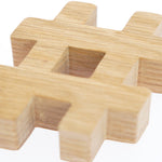 Close up of the Reel Wood eco-friendly hashtag symbol block on a white background