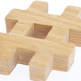 Close up of the Reel Wood eco-friendly hashtag symbol block on a white background