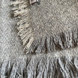 Close up of the tassels on the Respiin woollen throw blanket in the grey colour