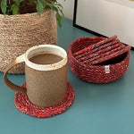 Respiin recycled cotton multicoloured coasters in its matching holder on top of a surface with a mug on top of a coaster