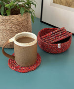Respiin recycled cotton multicoloured coasters in its matching holder on top of a surface with a mug on top of a coaster