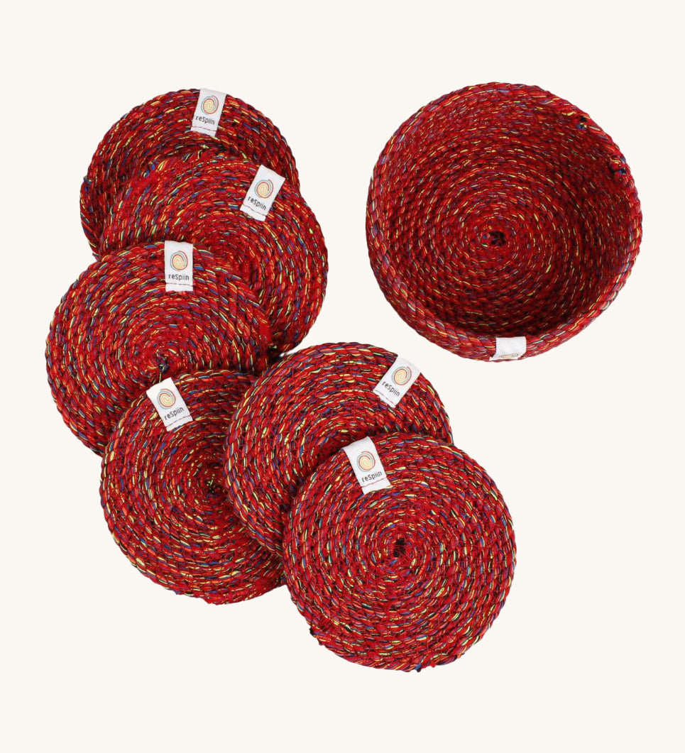 A set of 6 Respiin multicoloured recycled cotton coasters with a matching holder. Features a brand patch stitched on the rim.