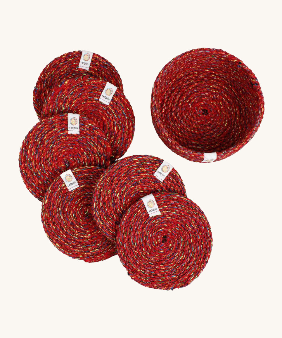 A set of 6 Respiin multicoloured recycled cotton coasters with a matching holder. Features a brand patch stitched on the rim.
